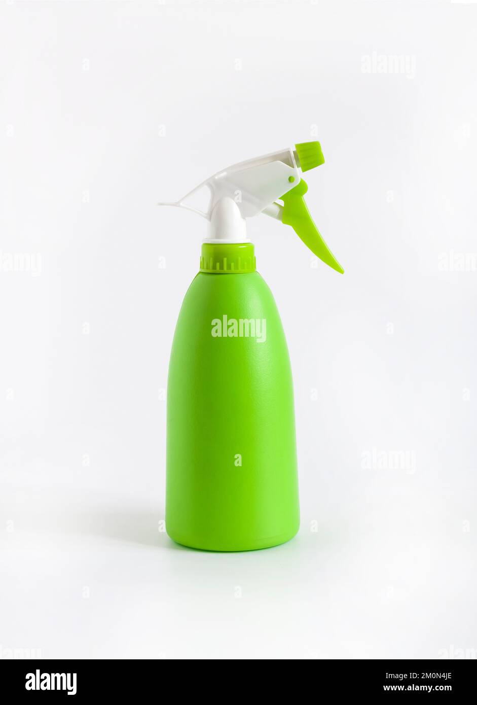 Green plastic spray bottle on white background Stock Photo