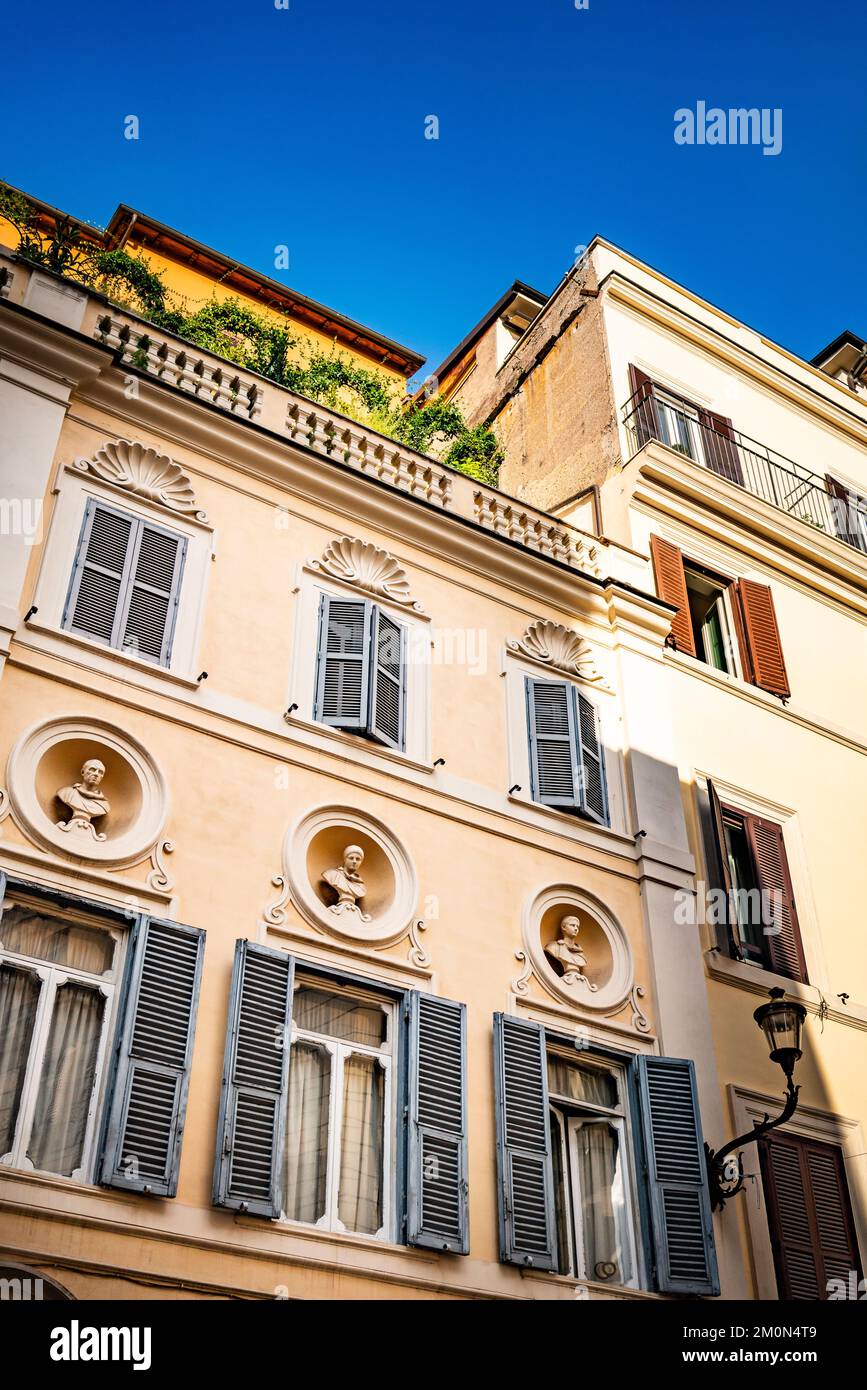 Quiet street in central Rome, Italy with figure heads Stock Photo Alamy
