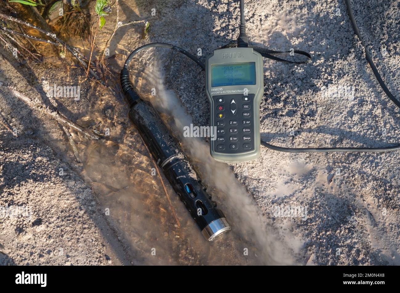 Hanna probe and meter measuring pH of water in the headwaters of the River Doethie, Bryn Deilos, Wales, UK Stock Photo