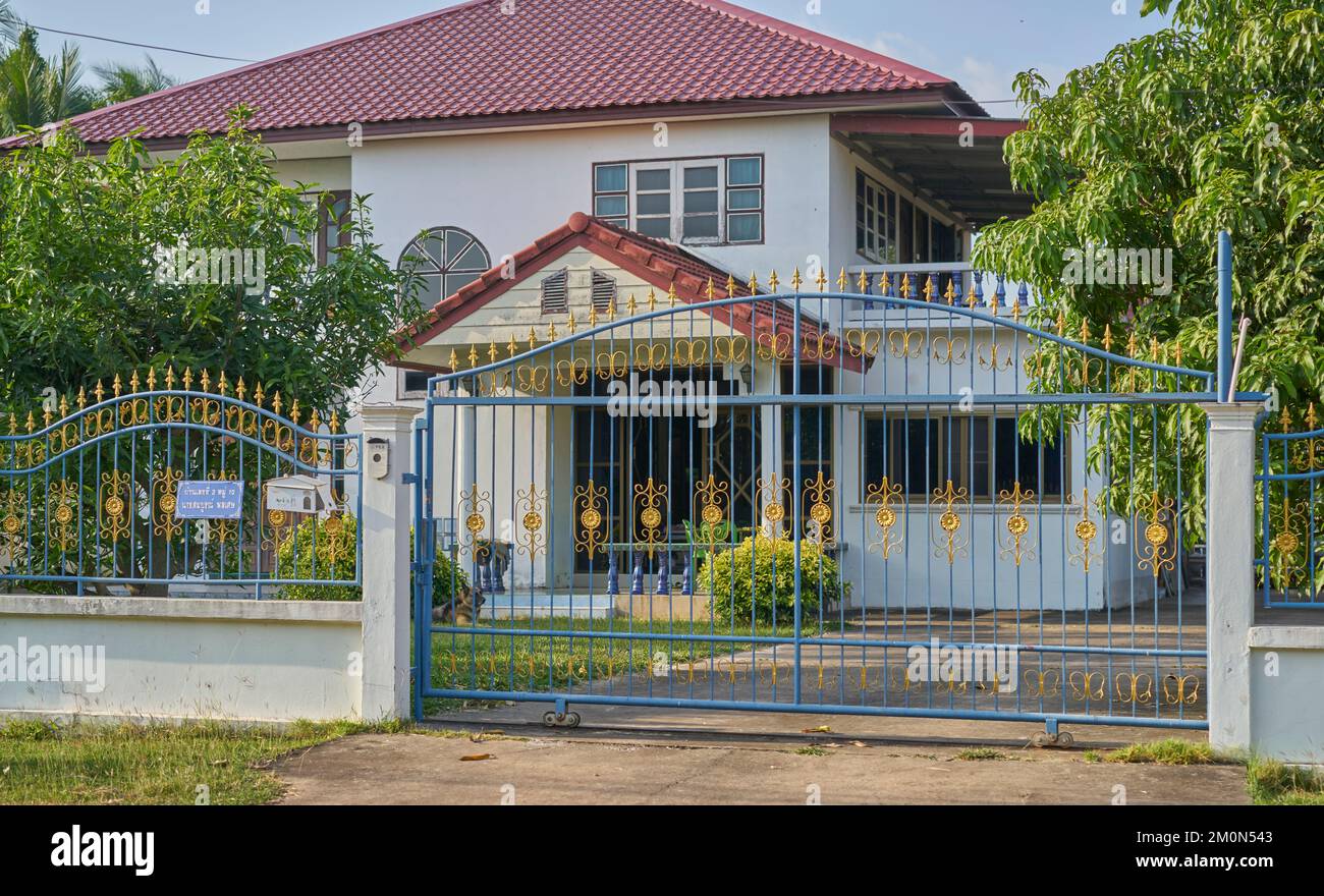 A house and ornate wrought iron sliding gate in countryside. Stock Photo