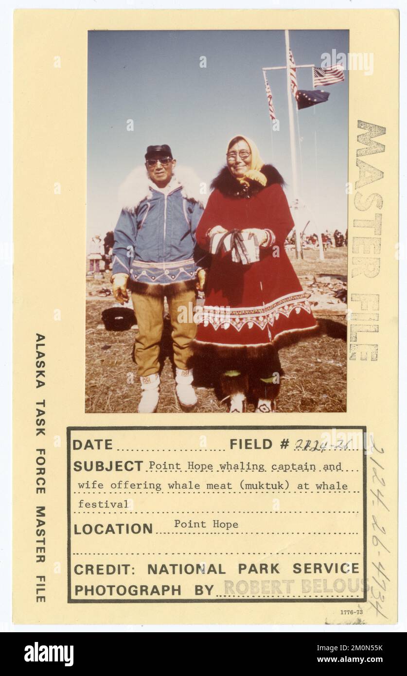 Point Hope whaling captain and wife offering whale meat (muktuk) at