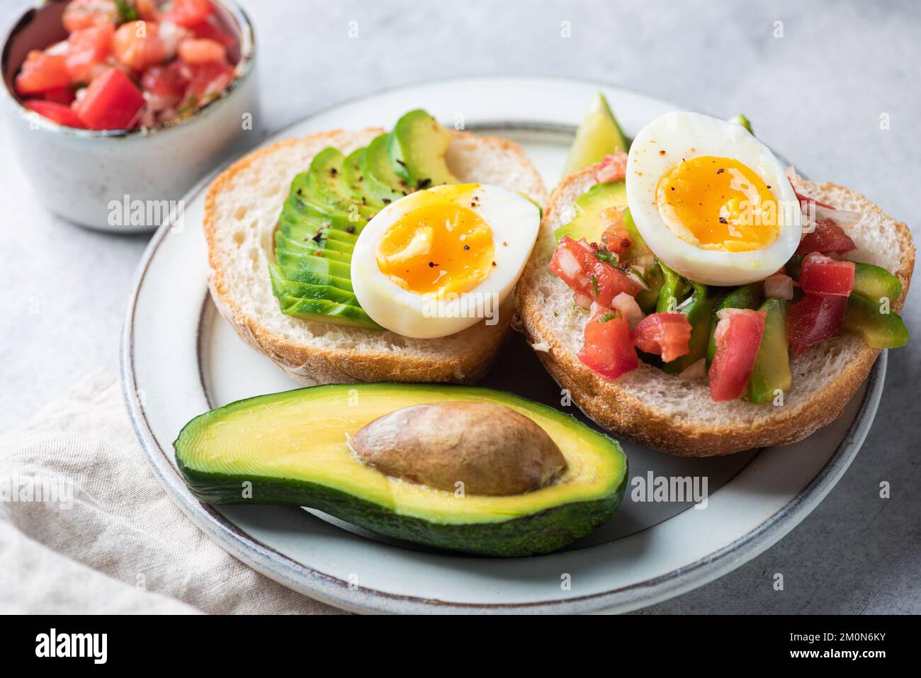 Toast with egg, tomato and avocado on a plate, healthy vegetarian food Stock Photo