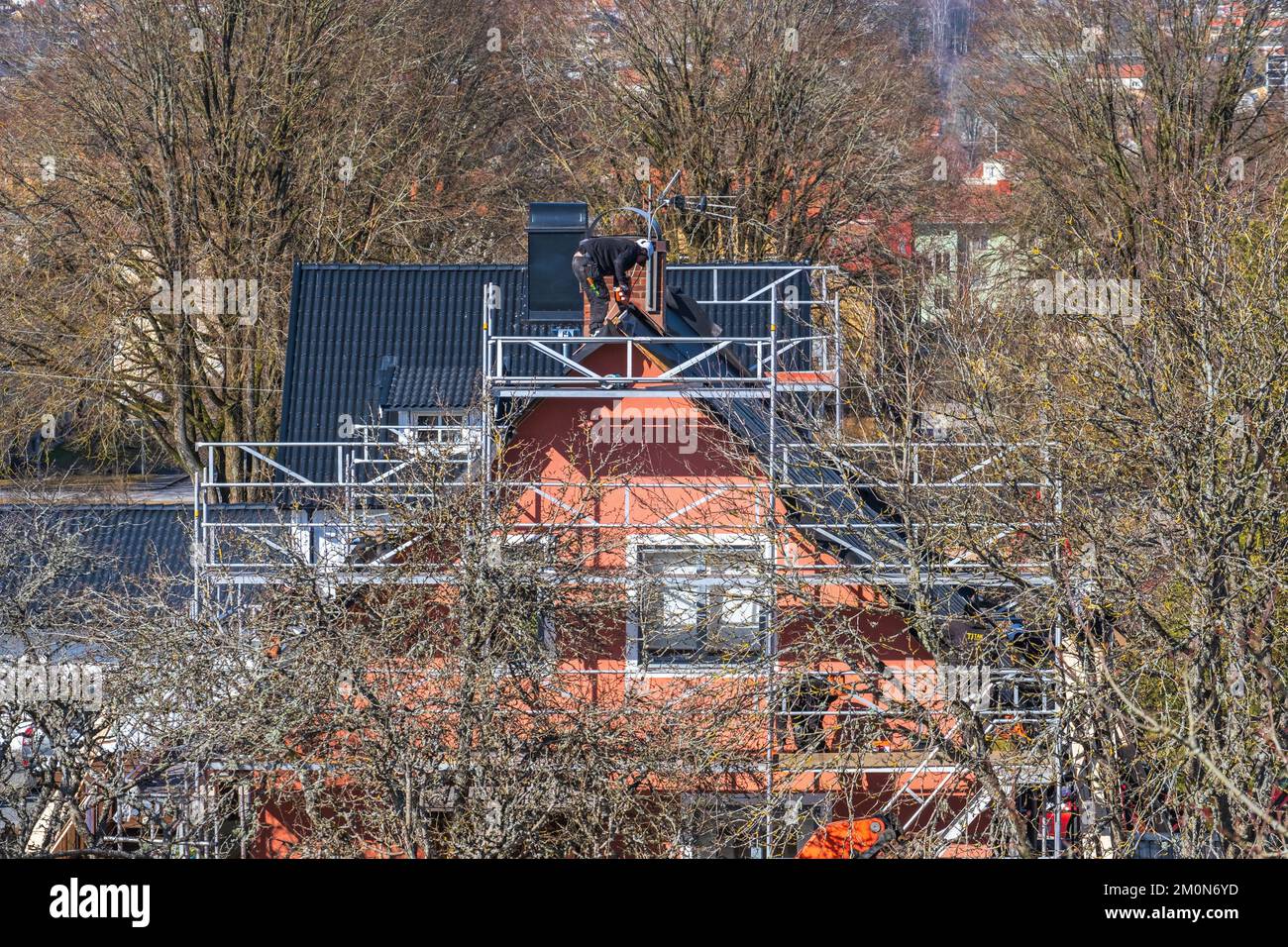 Roofers working on a residential building Stock Photo