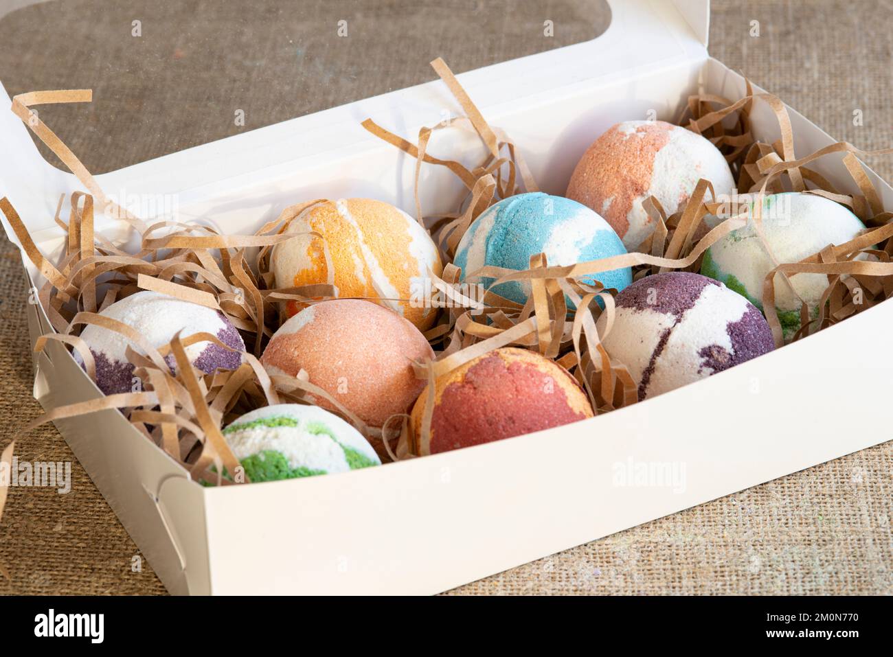 Carton box with bath bombs on table Stock Photo
