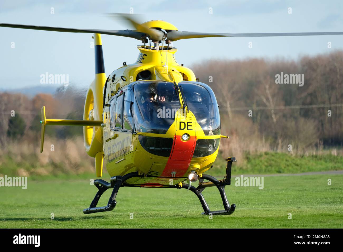 National Grid - Western Power Distribution ( WPD ) Airbus EC135 helicopter taking off to inspect electricity powerline infrastructure in December 2022 Stock Photo