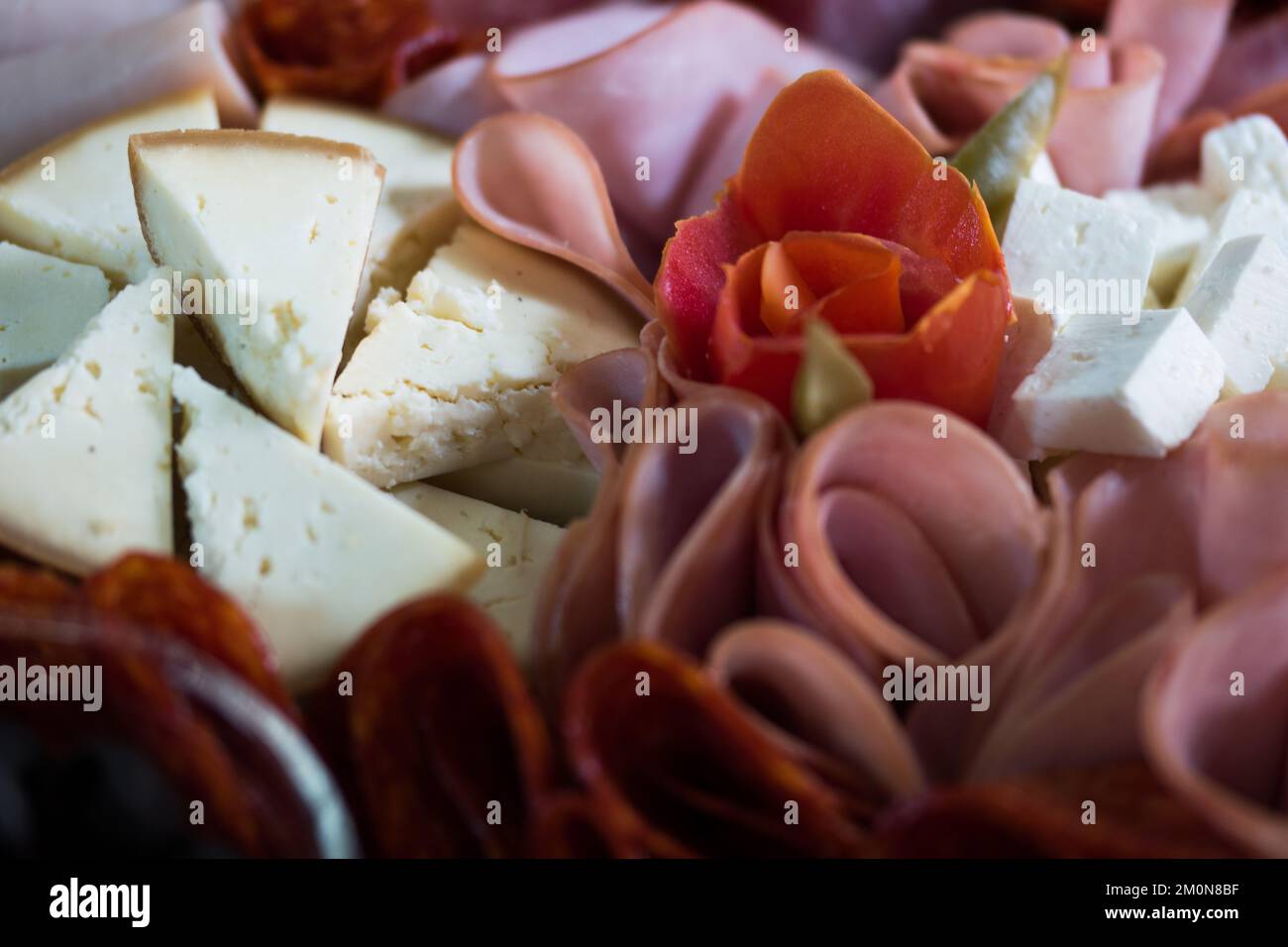 A closeup shot of a table with mix of meats and cheese Stock Photo