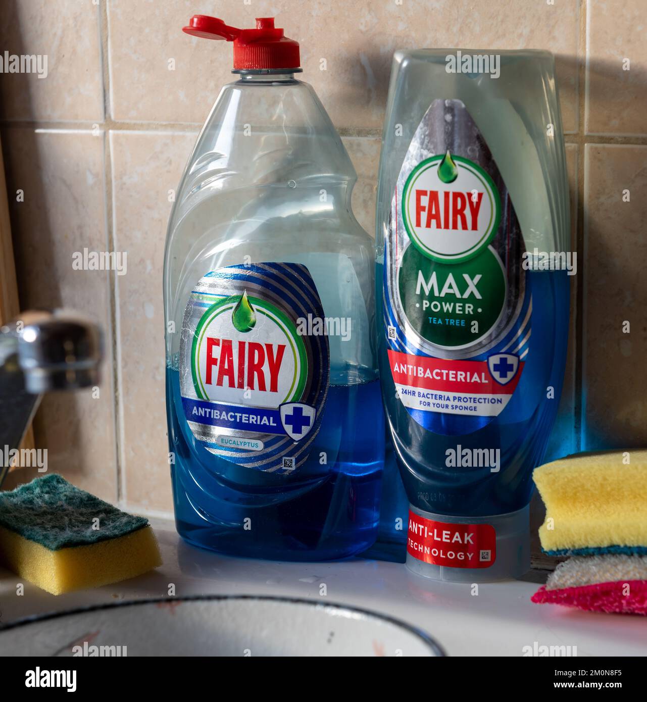 London. UK- 12.07.2022. A bottle of Fairy Max and Fairy antibacterial washing up liquid by a kitchen sink. Stock Photo