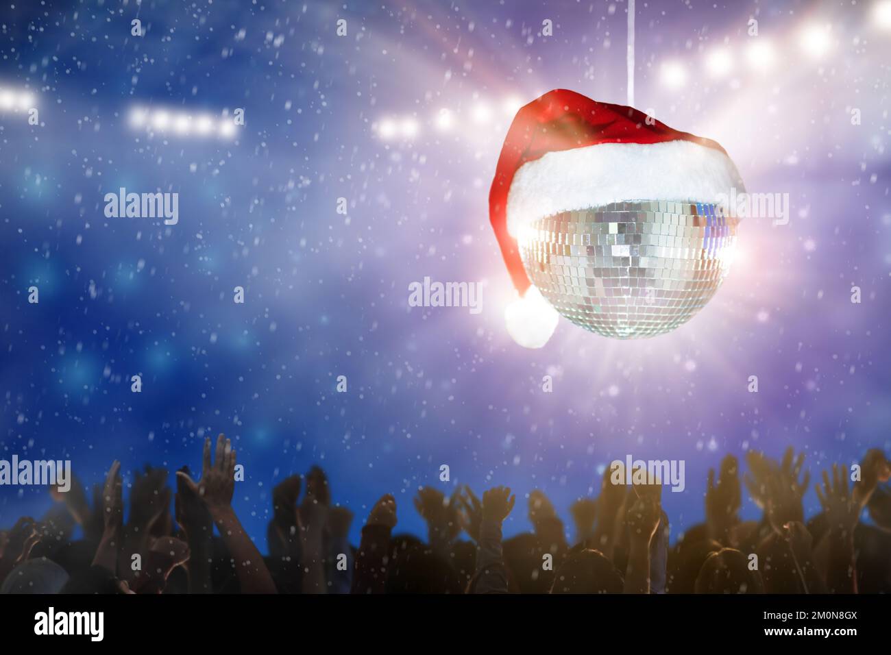 Christmas disco party in a night club. Glowing Santa hat lantern disco