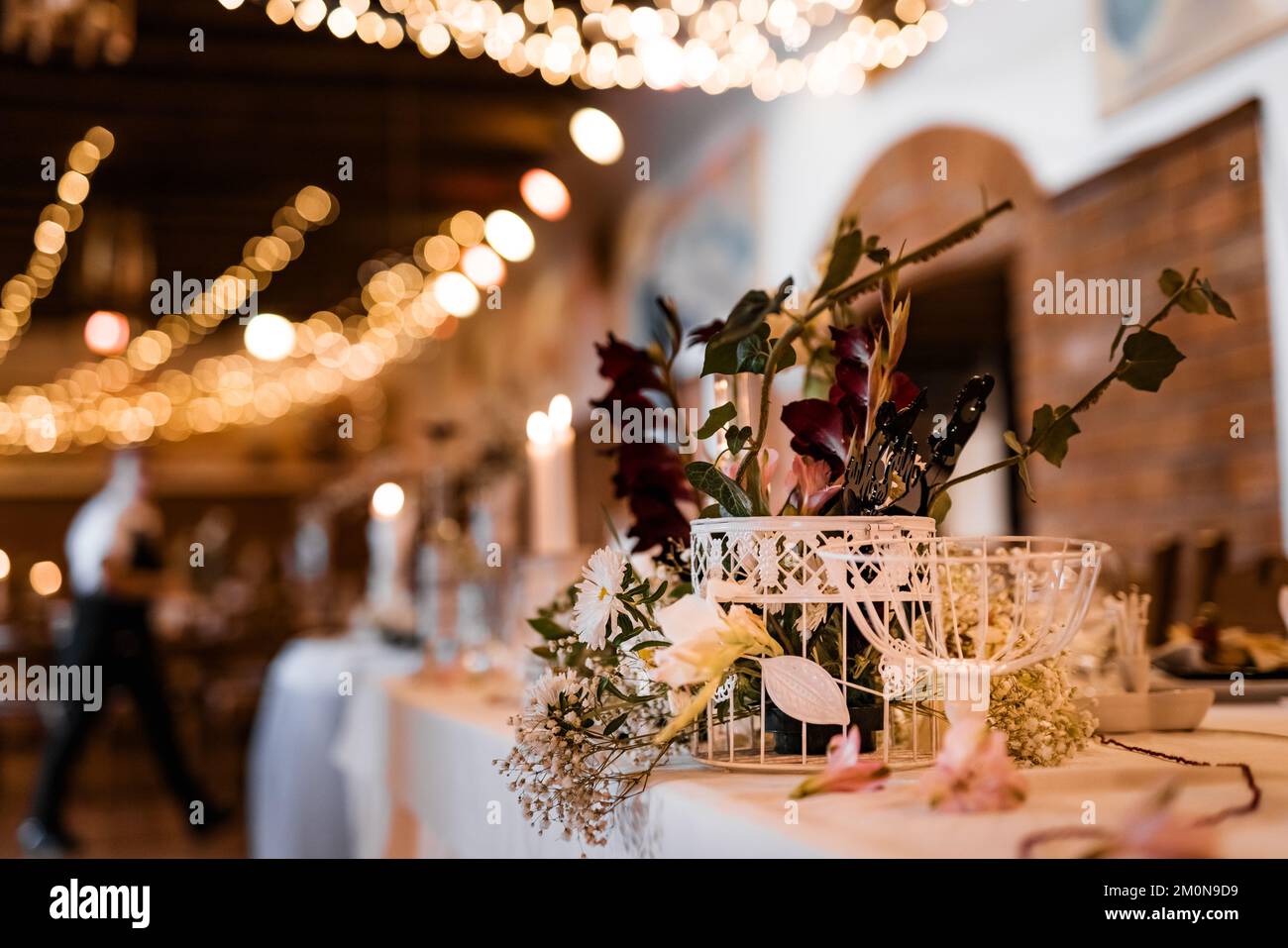 Table setting for wedding party decor flowers lights blurred background Stock Photo