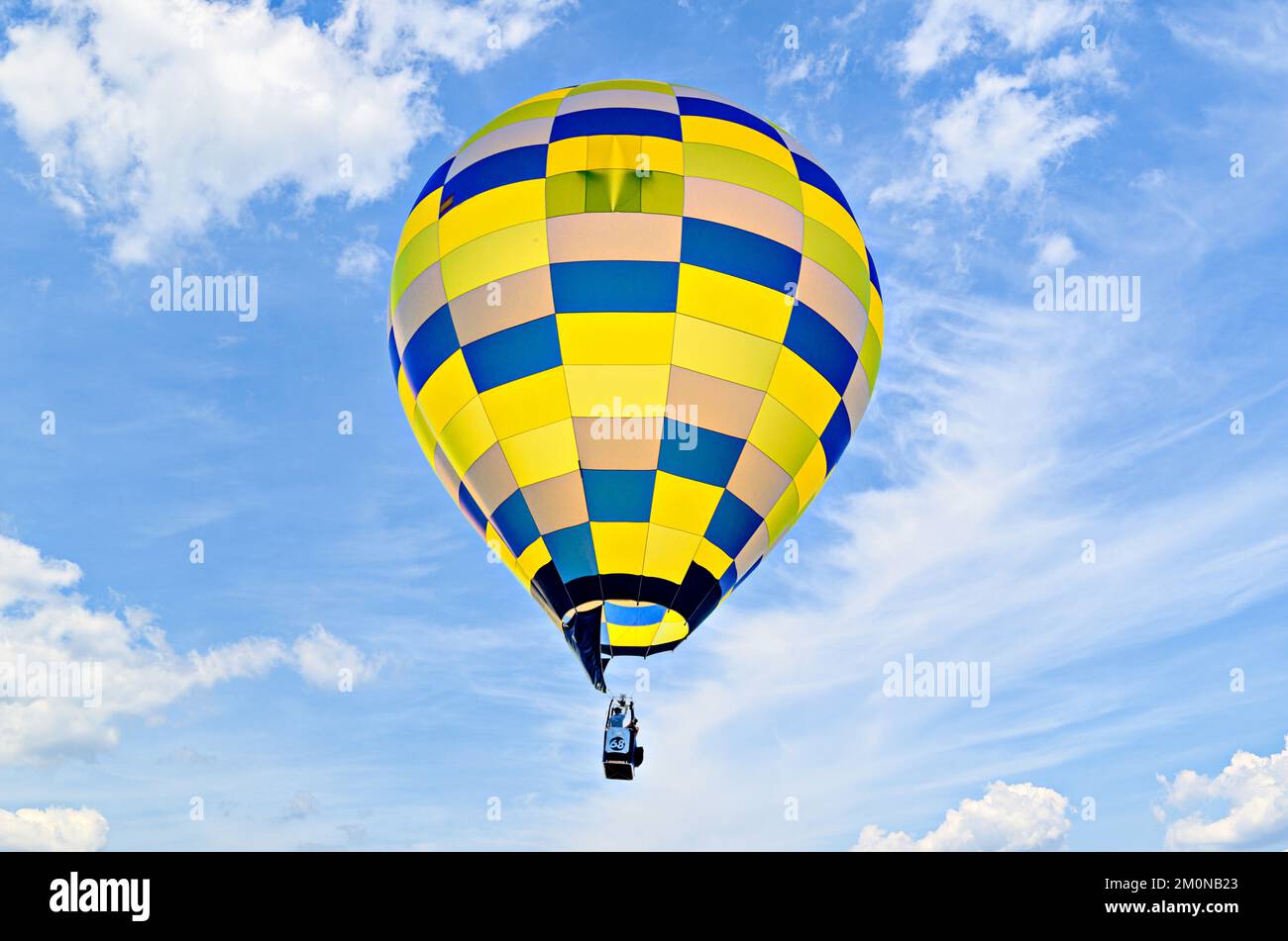 Colorful hot air balloon flying over blue sky Stock Photo - Alamy