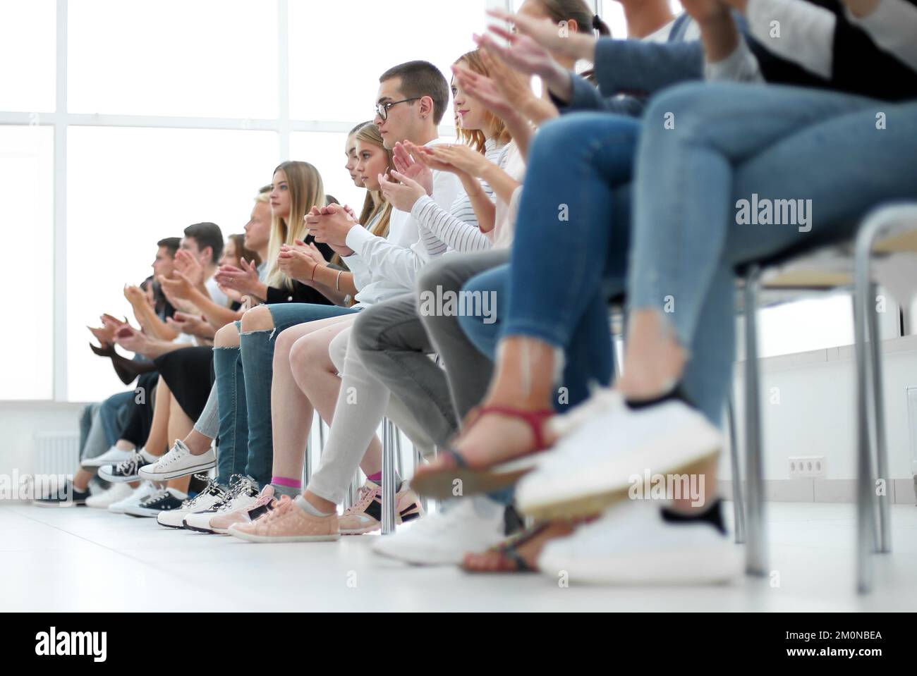 background image of young people applauding in the conference ro Stock Photo