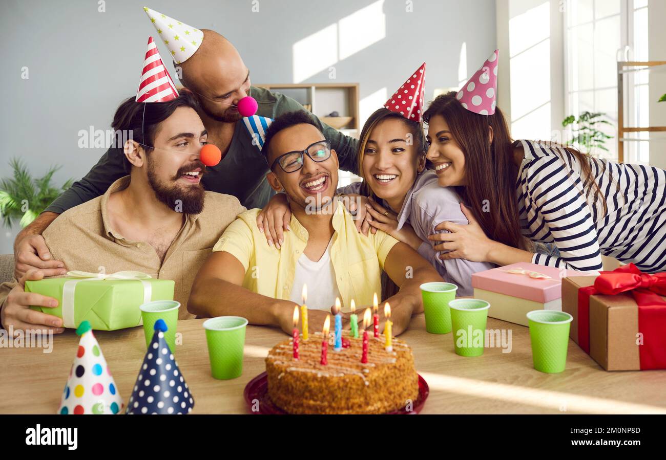 Happy young people congratulate friend with birthday Stock Photo