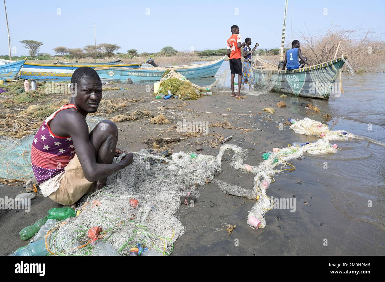 KENYA, Turkana, village Anam at Lake Turkana, fisherman, plastic waste, old PET softdrink bottles / KENIA, Turkana, Dorf Anam am Lake Turkana, Fischer, Plastikmüll Stock Photo