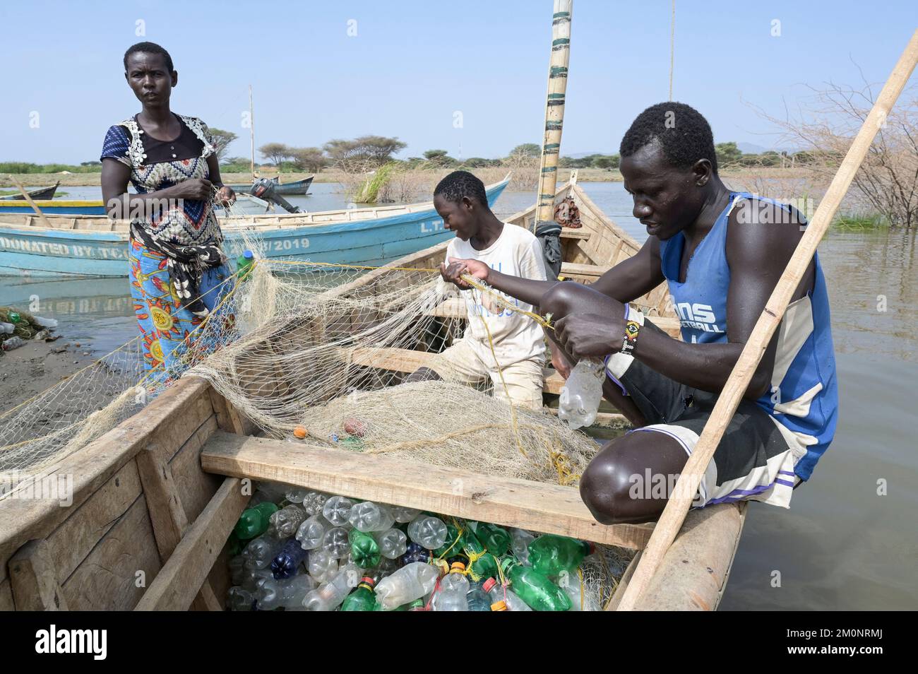 KENYA, Turkana, village Anam at Lake Turkana, fisherman, plastic waste, old PET softdrink bottles / KENIA, Turkana, Dorf Anam am Lake Turkana, Fischer, Plastikmüll Stock Photo