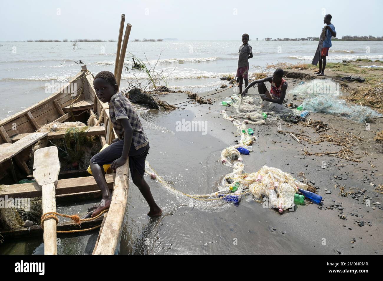 KENYA, Turkana, village Anam at Lake Turkana, fisherman, plastic waste, old PET softdrink