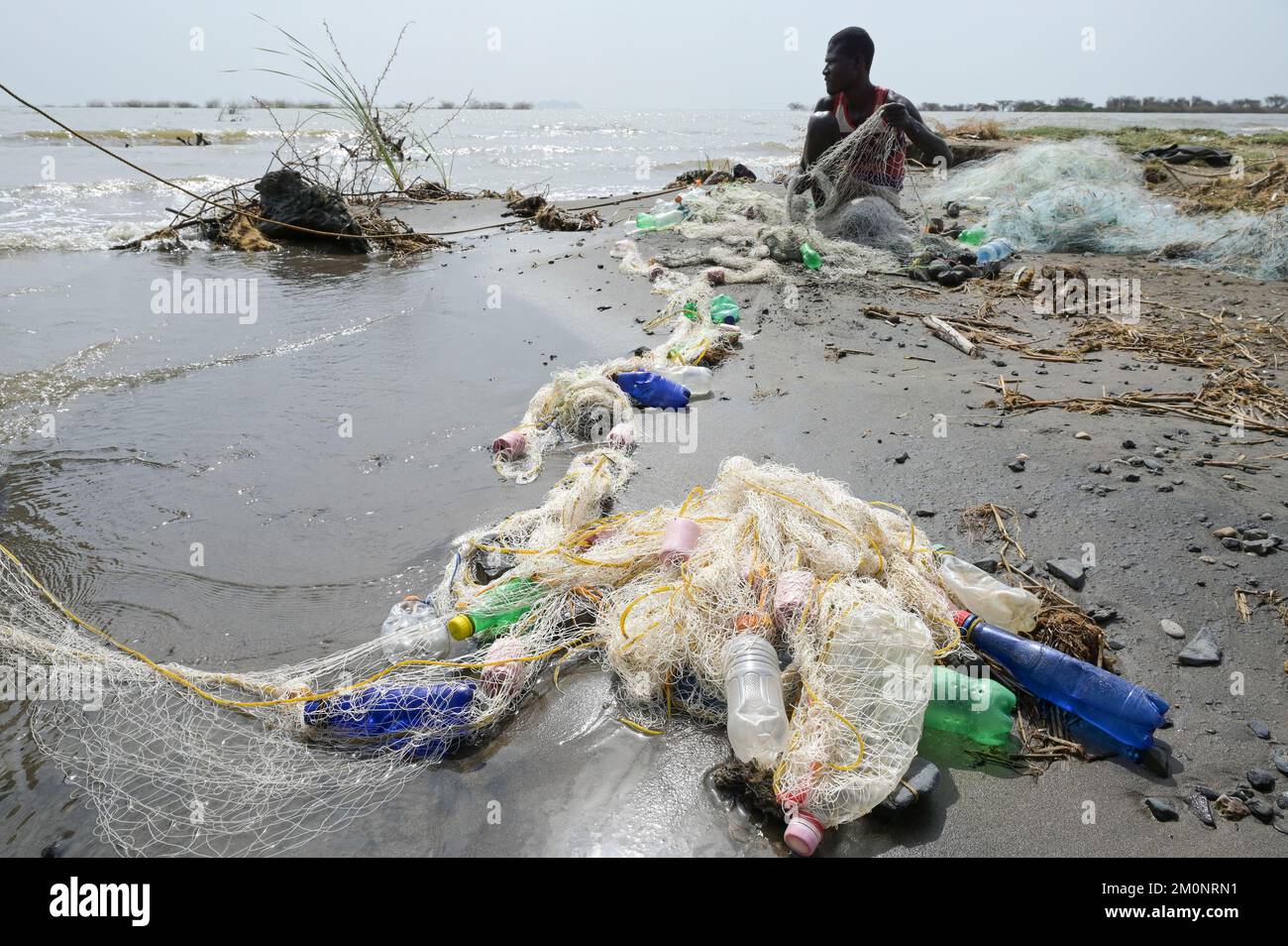 KENYA, Turkana, village Anam at Lake Turkana, fisherman, plastic waste, old PET softdrink