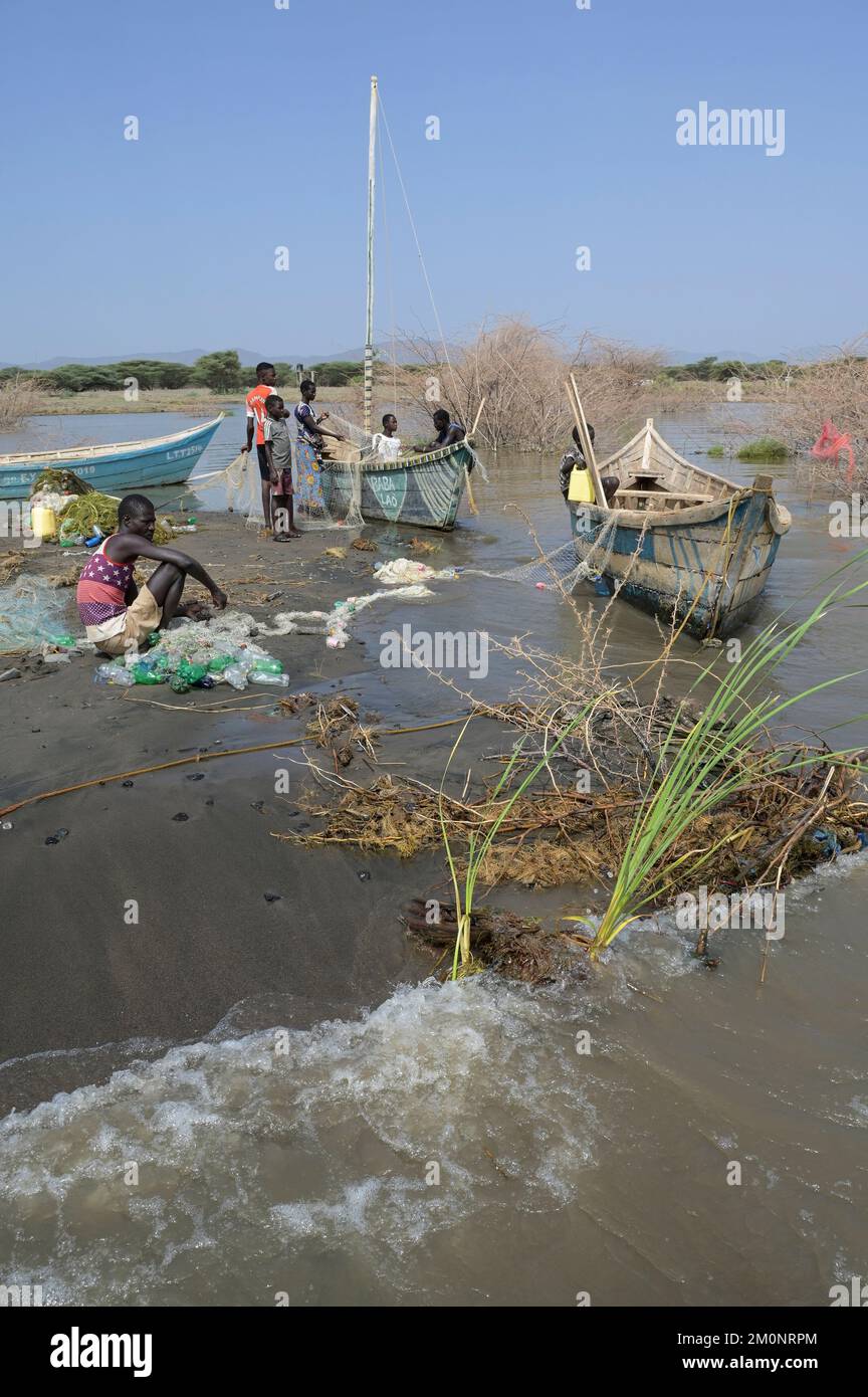 KENYA, Turkana, village Anam at Lake Turkana, fisherman, plastic waste, old PET softdrink