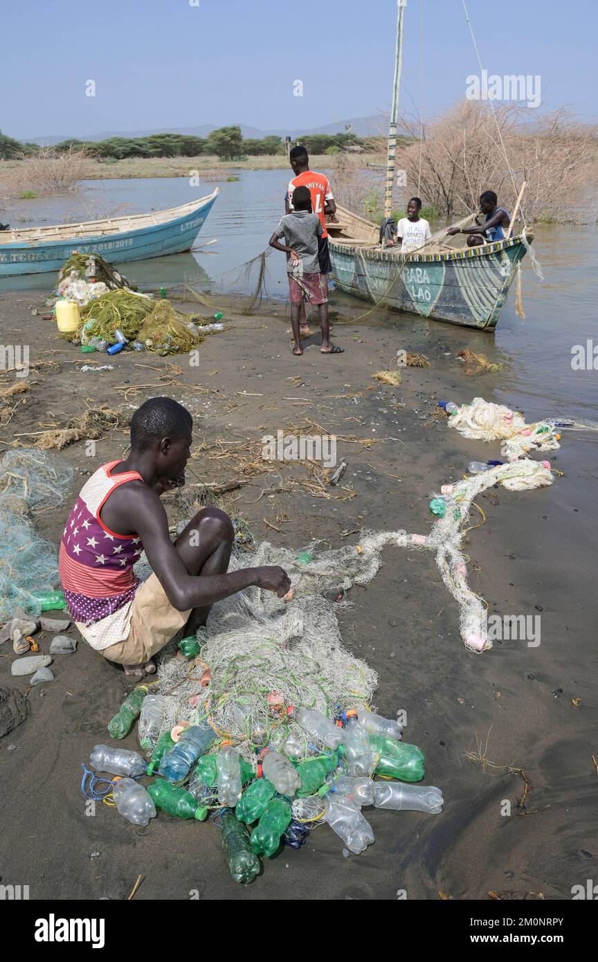 KENYA, Turkana, village Anam at Lake Turkana, fisherman, plastic waste, old PET softdrink