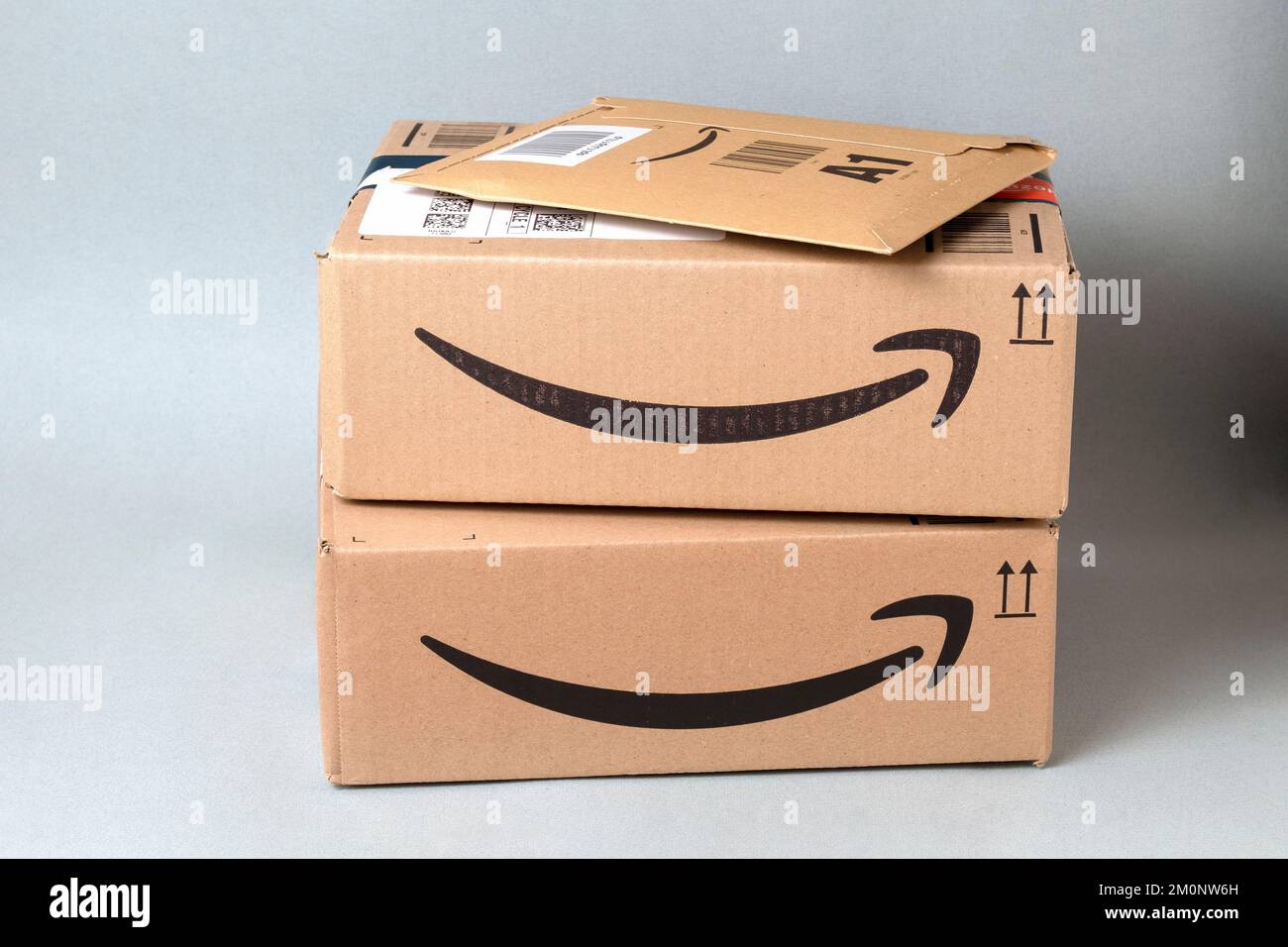 Two Amazon Prime boxes and an Amazon envelope on a table waiting to be opened.  The packages have just been delivered to a #UK home Stock Photo
