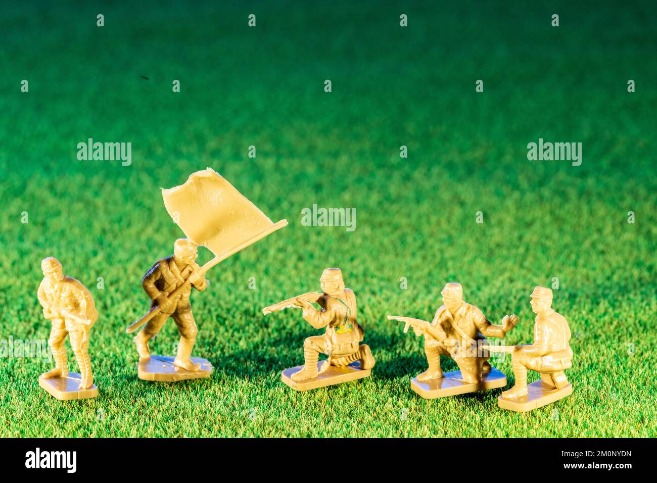 Airfix HO/00 scale plastic model figures. Five Japanese infantry from world war two, various figures in poses on green grass texture background Stock Photo