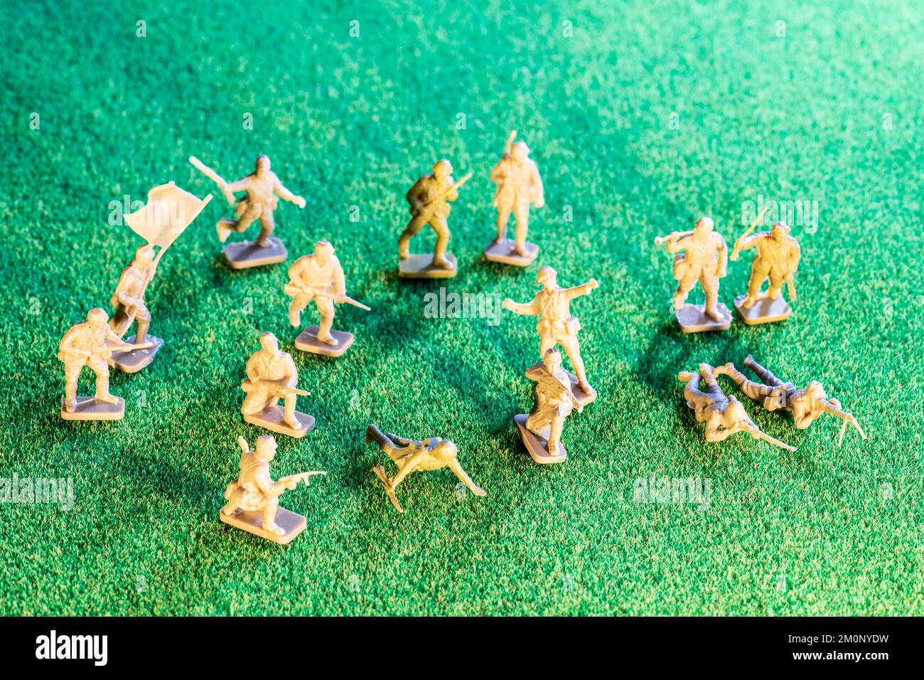 Airfix HO/00 scale plastic model figures. Japanese infantry from world war two, various figures in poses on green grass texture background Stock Photo