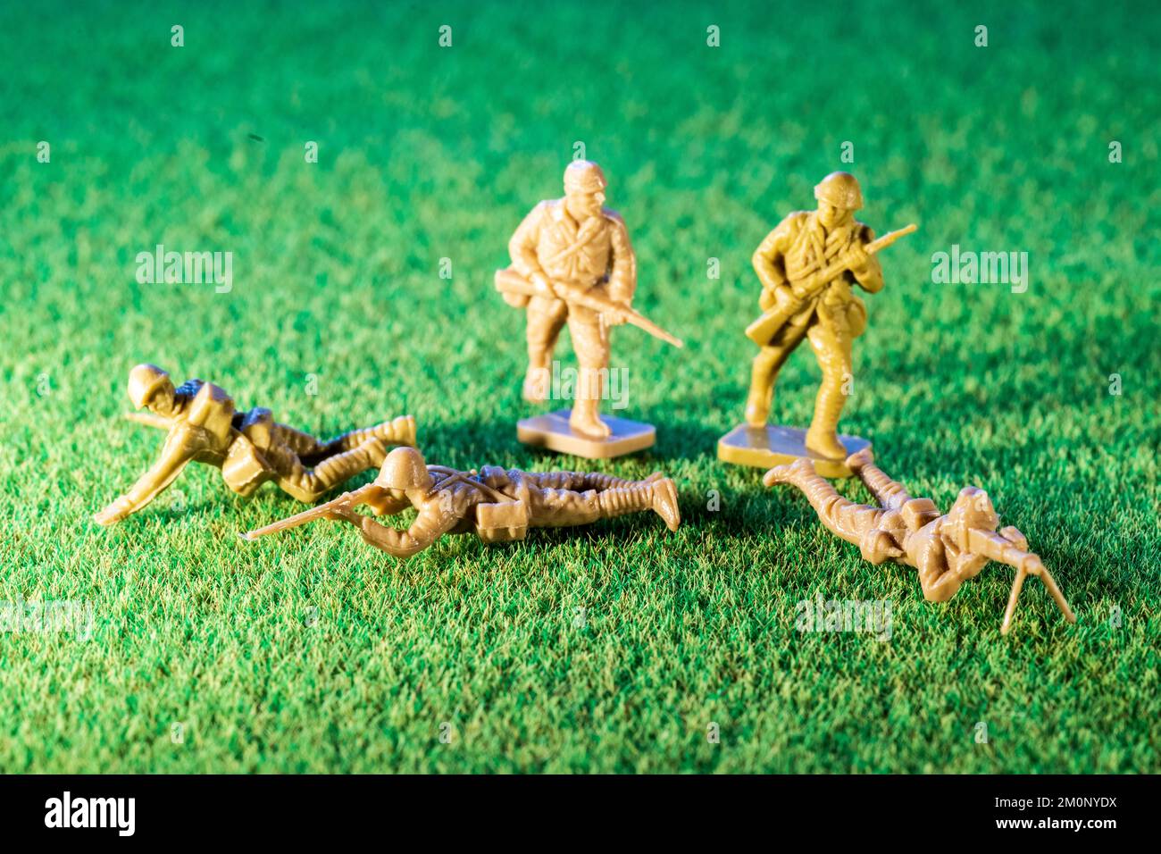 Airfix HO/00 scale plastic model figures. Five Japanese infantry from world war two, various figures in poses on green grass texture background Stock Photo