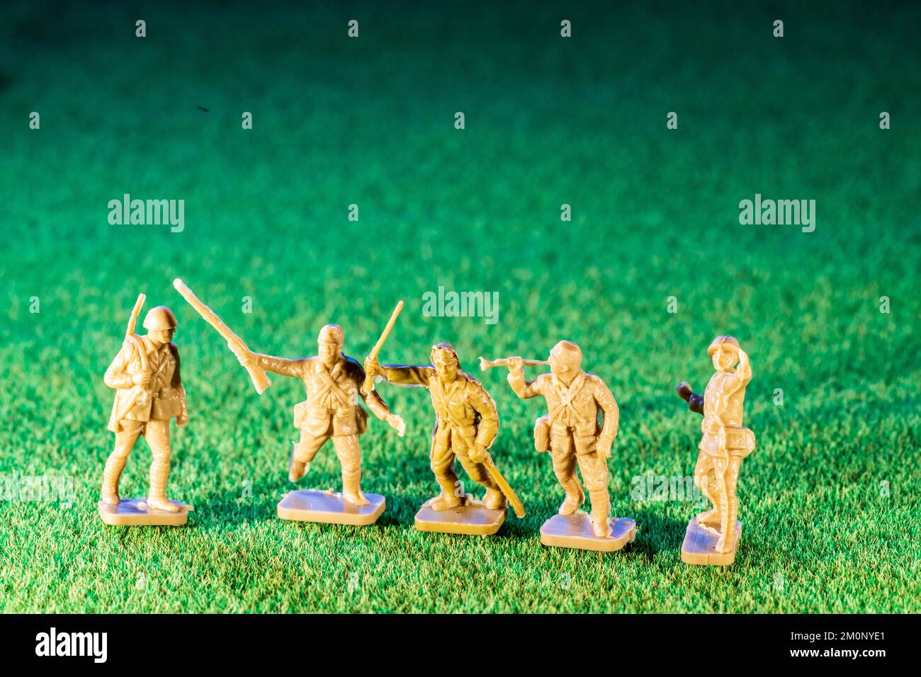 Airfix HO/00 scale plastic model figures. Five Japanese infantry from world war two, various figures in poses on green grass texture background Stock Photo