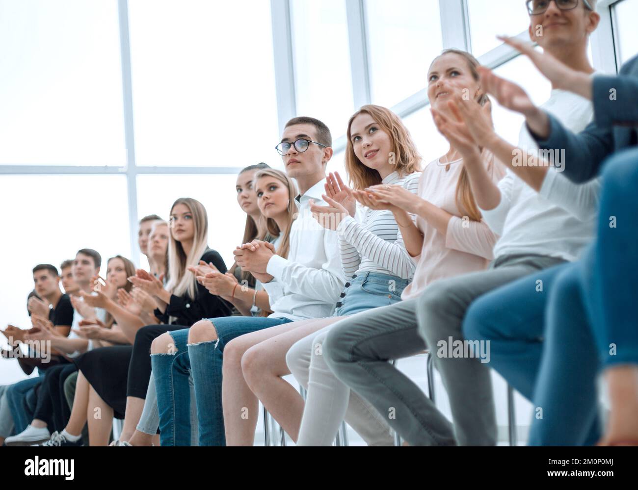 group of diverse young people sitting in a row Stock Photo - Alamy