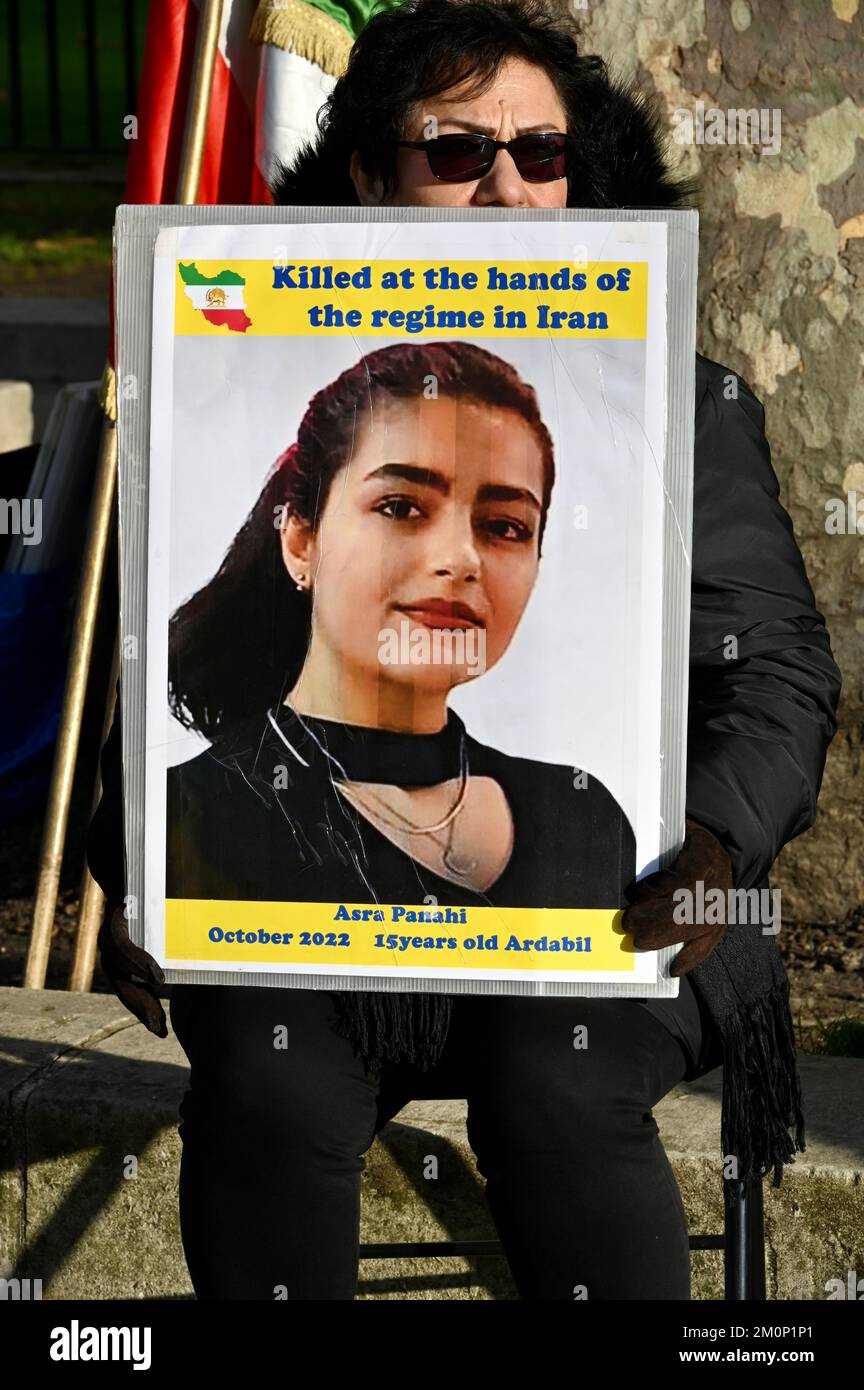 Activist holding a portrait of Asra Panahi who was killed during the Mahsa Amini protests in the city of Ardabil. Freedom for Iran Protest, Opposite Downing Street, Whitehall, London. UK Stock Photo