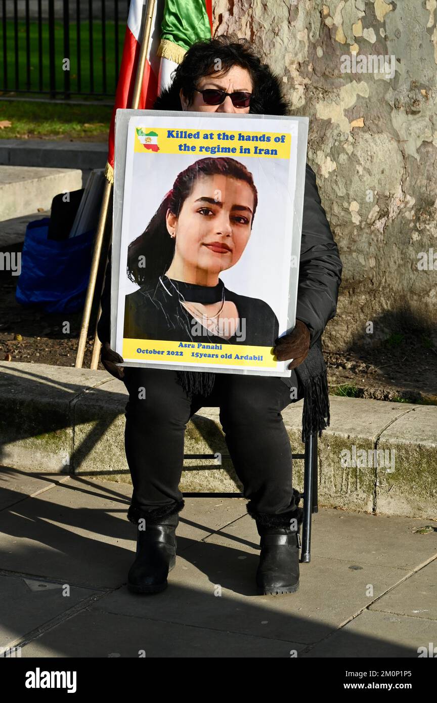 Activist holding a portrait of Asra Panahi who was killed during the Mahsa Amini protests in the city of Ardabil. Freedom for Iran Protest, Opposite Downing Street, Whitehall, London. UK Stock Photo