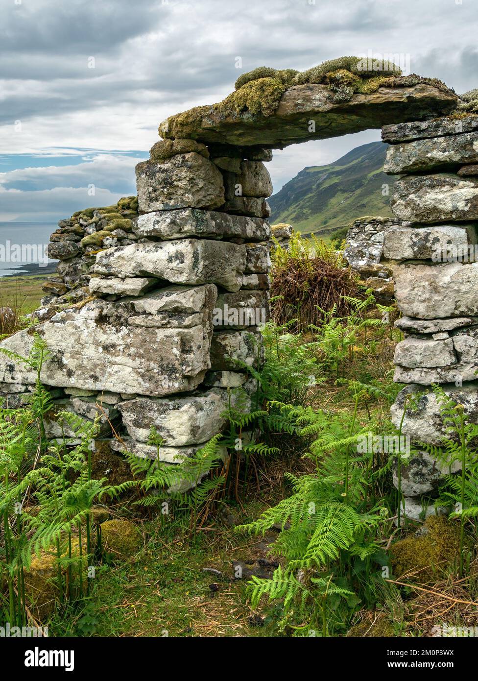 Old ruined croft house doorway with dry stone walls and lintel slab, Boreraig, Isle of Skye, Scotland, UK Stock Photo