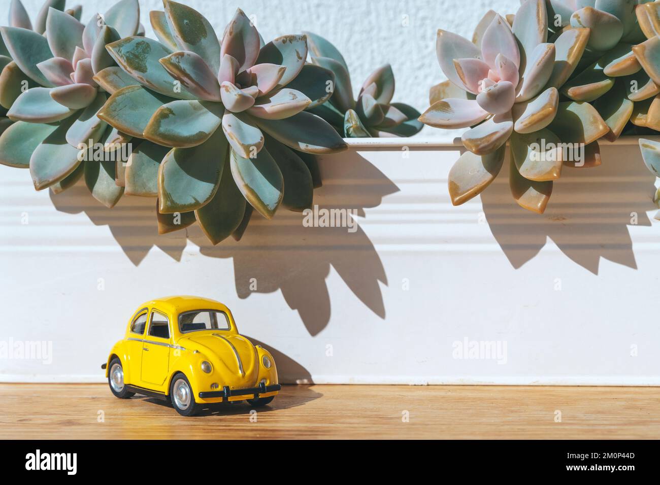 Travel car concept. Toy yellow car moves on against the backdrop of nature. Driving, adventure, discovery idea. High quality photo Stock Photo