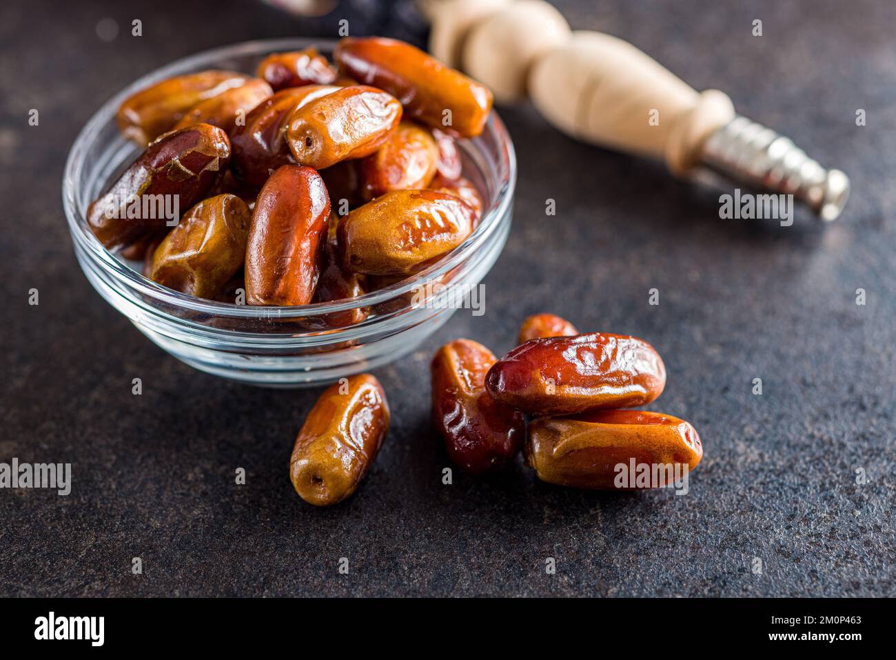 Dried dates fruit in bowl on the black table. Stock Photo