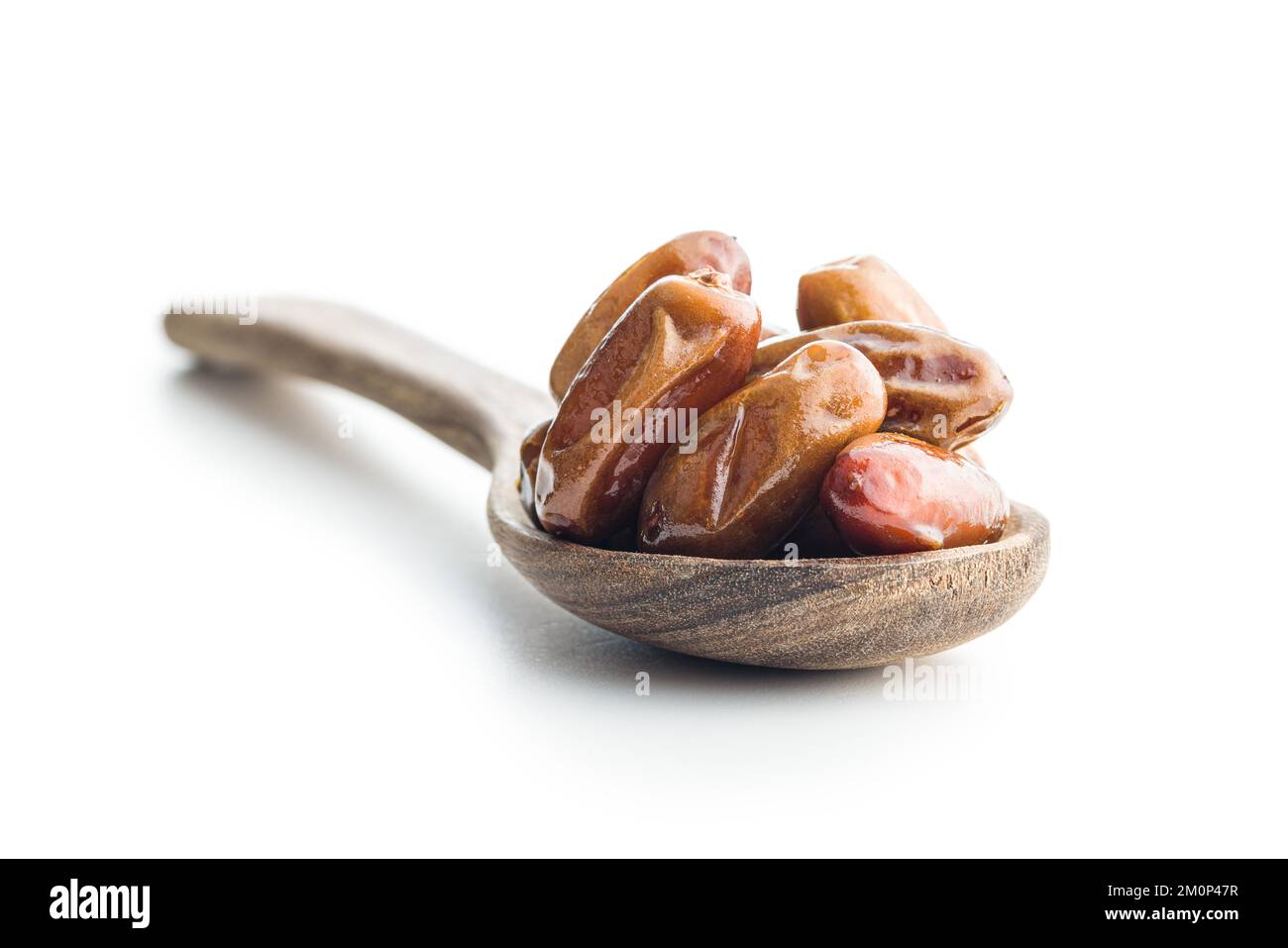 Dried dates fruit in spoon isolated on the white background Stock Photo ...