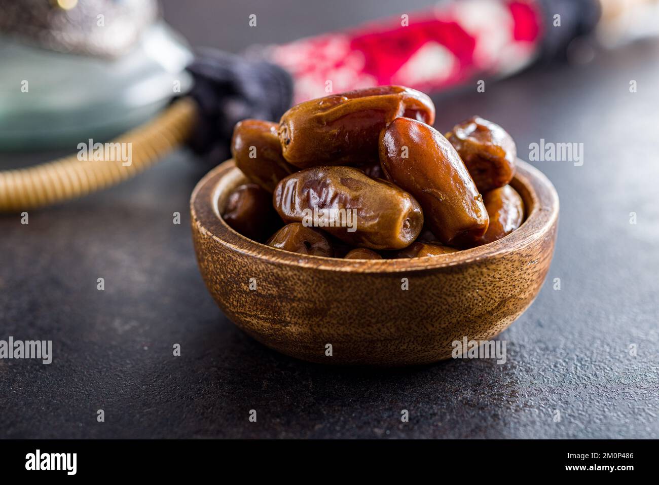 Dried dates fruit in bowl on the black table. Stock Photo