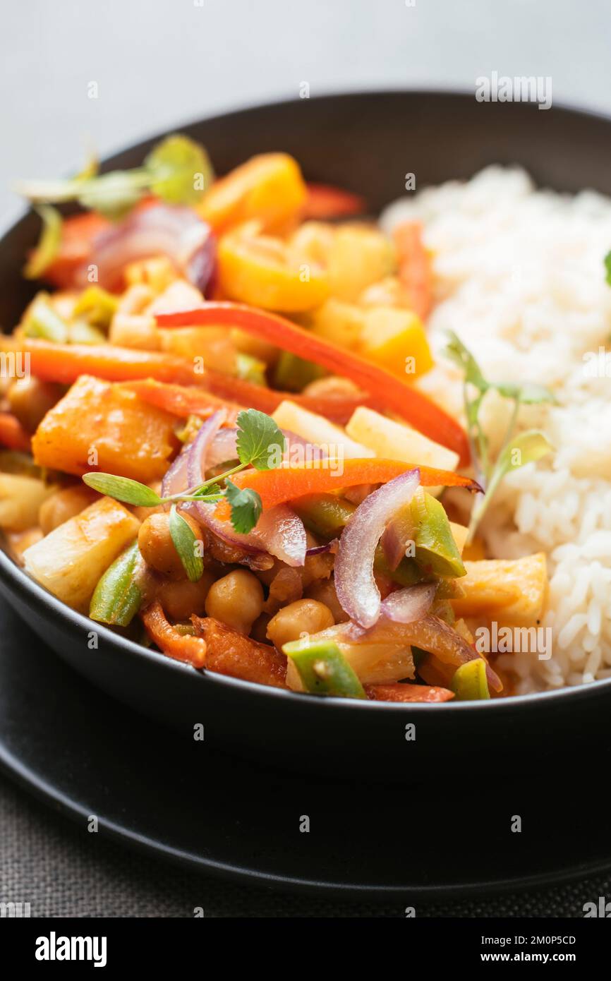 Thai Curried Winter Squash with Green Beans, Chickpeas and Pineapple on rice. Stock Photo