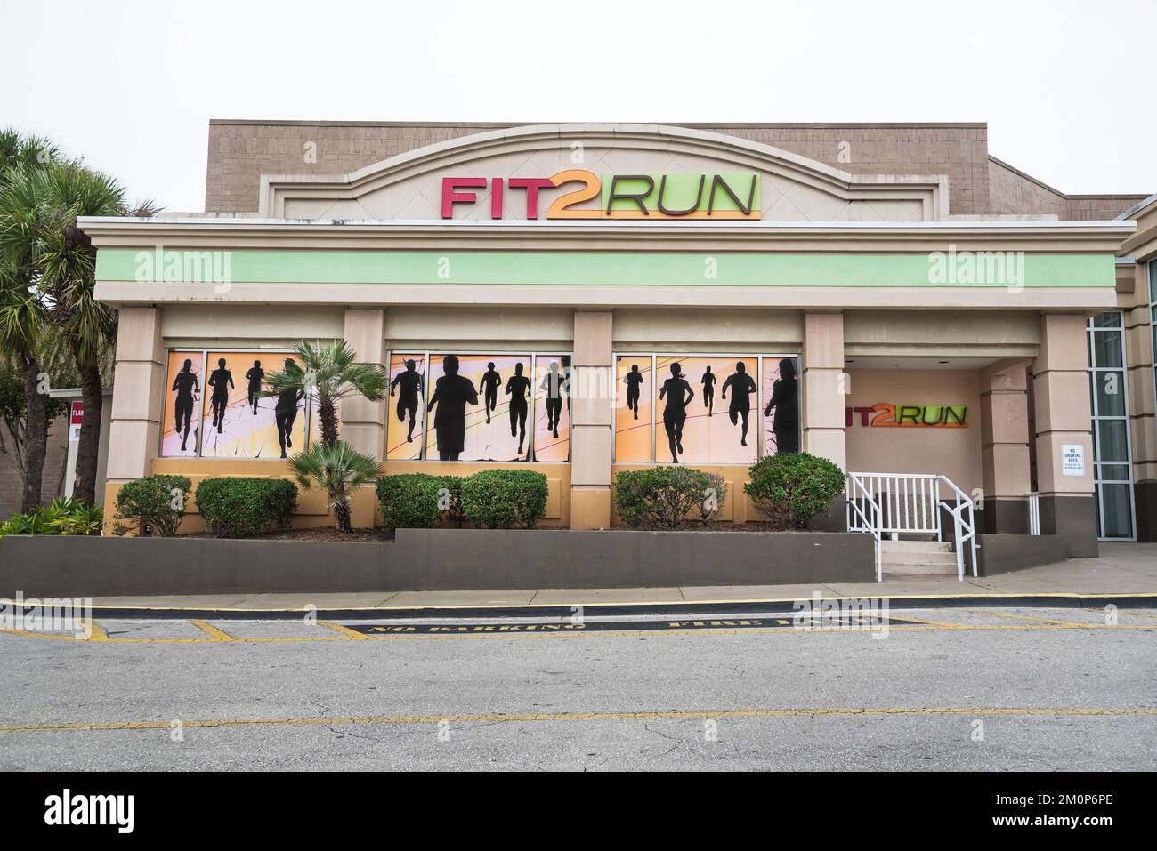 Mural of runners in silhouette grace the exterior of FIT 2 RUN, fitness training center in a Florida shopping mall. Stock Photo