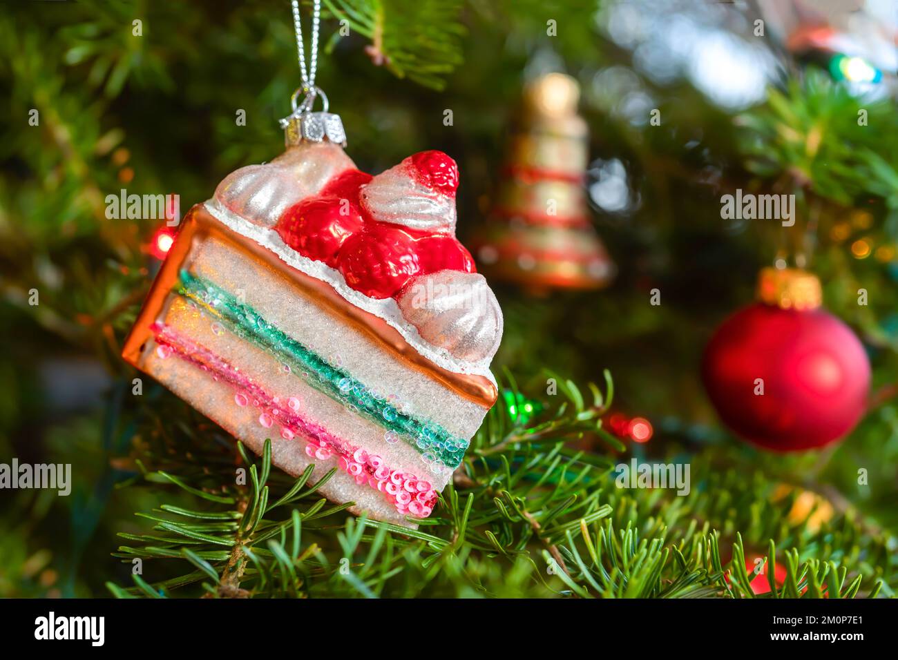 Layer cake hanging ornament in the Christmas tree. Stock Photo