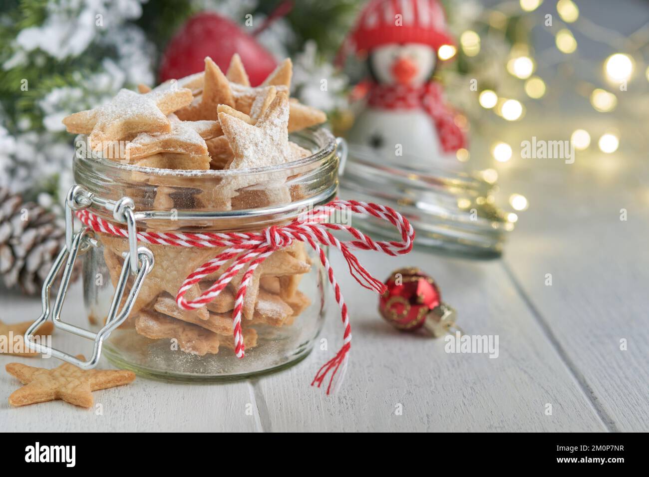 Christmas shortbread cookies or gingerbread stars with red ribbon ...