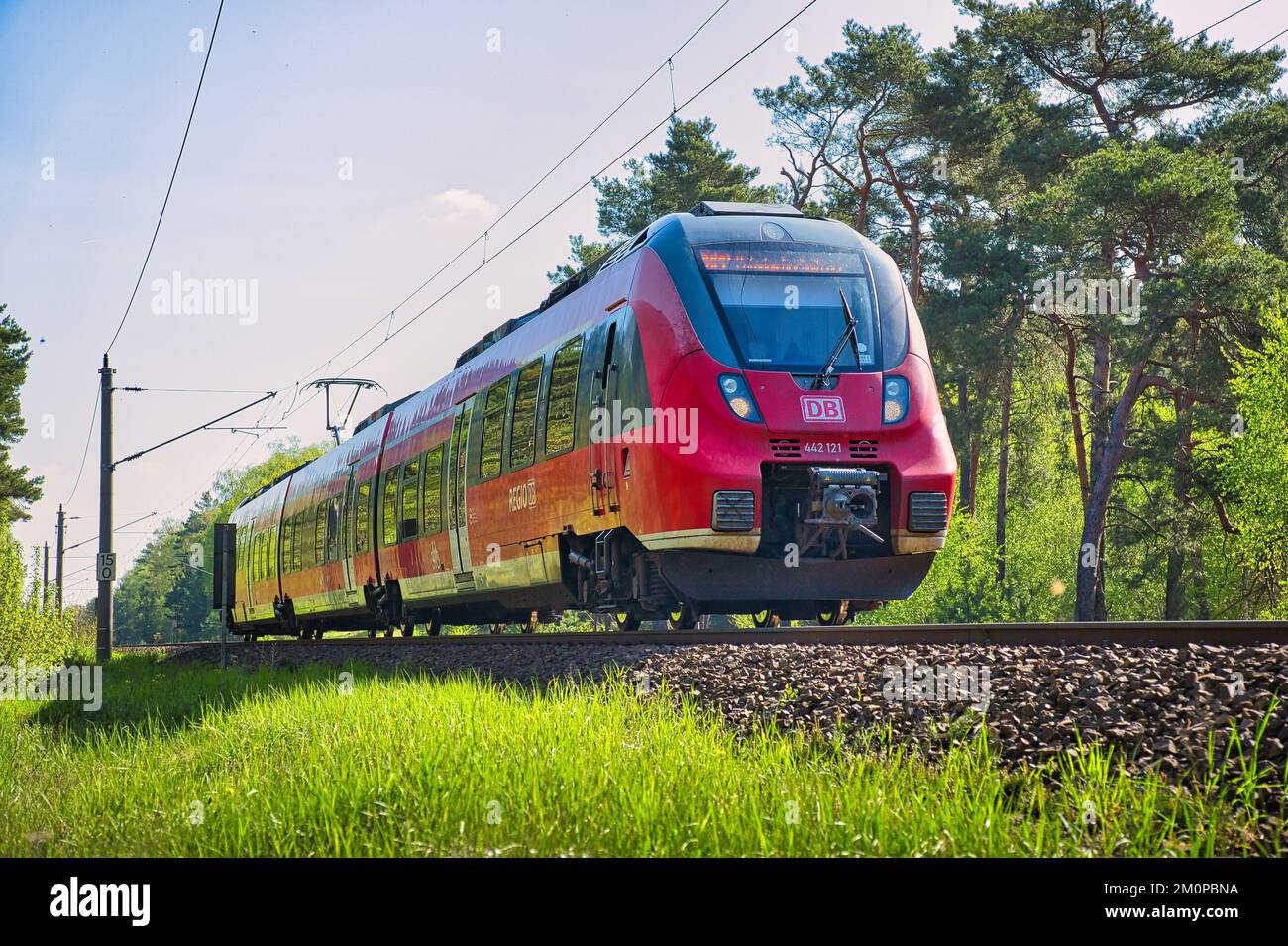 A Bombardier Talent 2 on a railroad surrounded by green trees Stock ...