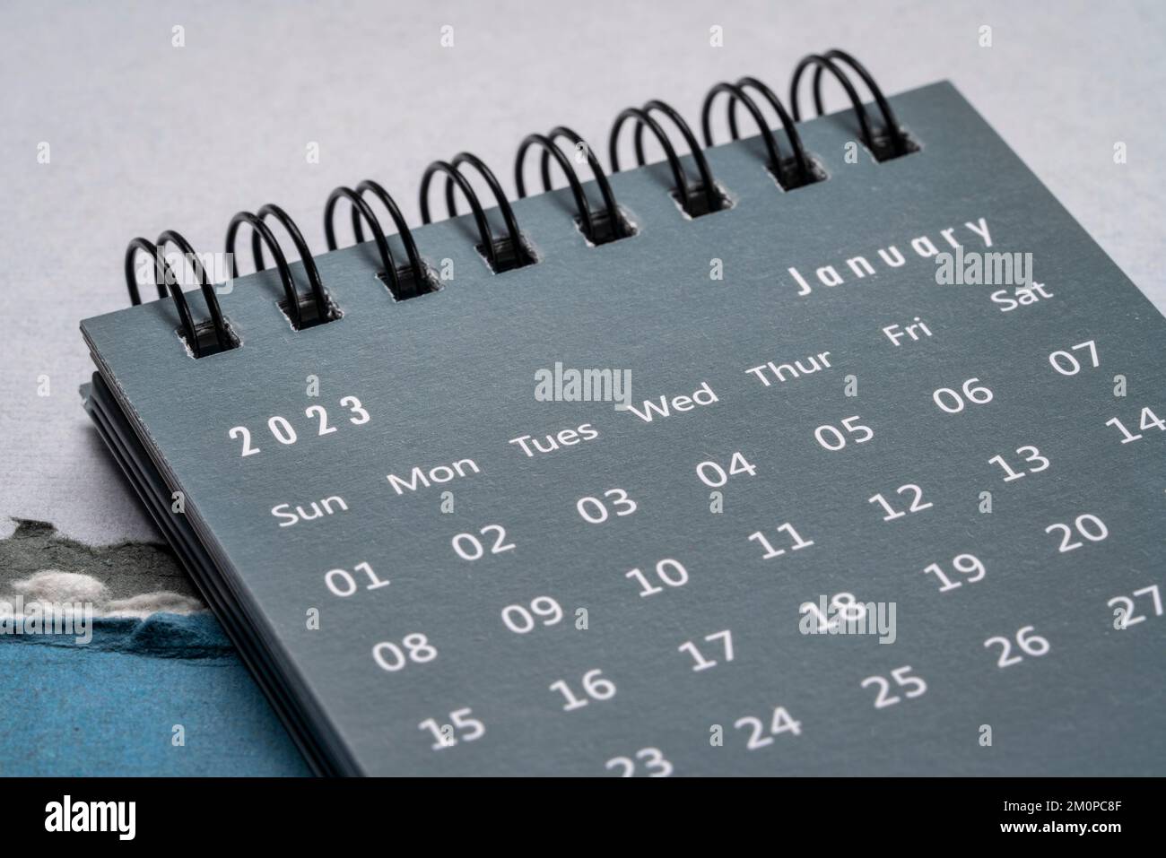 January 2023 - spiral desktop calendar against vivid marbled