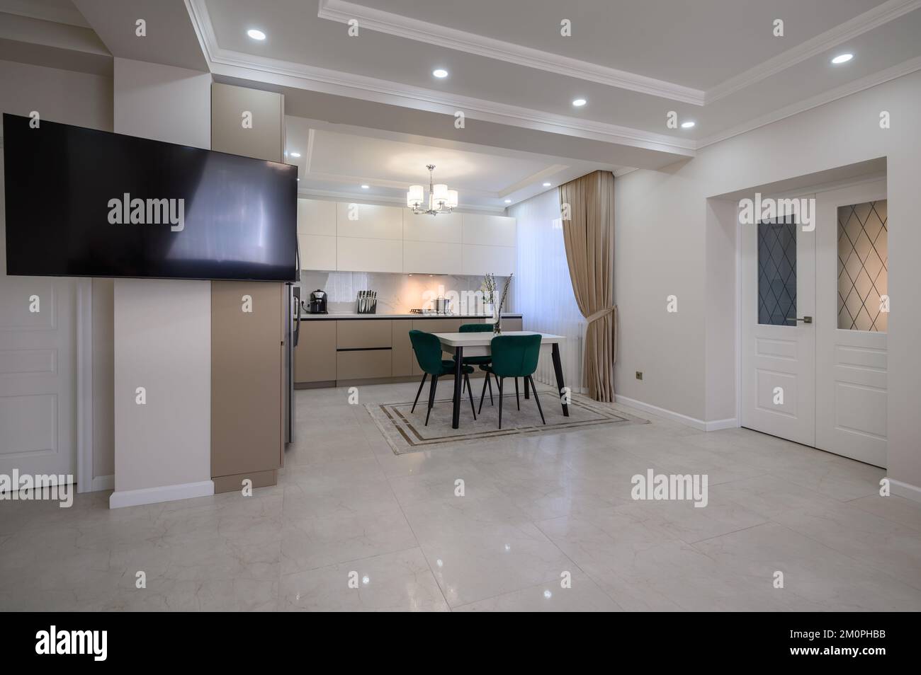 Modern white and beige large luxurious kitchen and dining table in