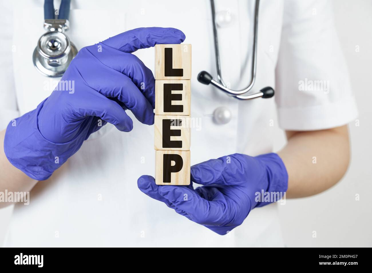 Medicine and health concept. The doctor holds cubes in his hands on which it is written - LEEP Stock Photo