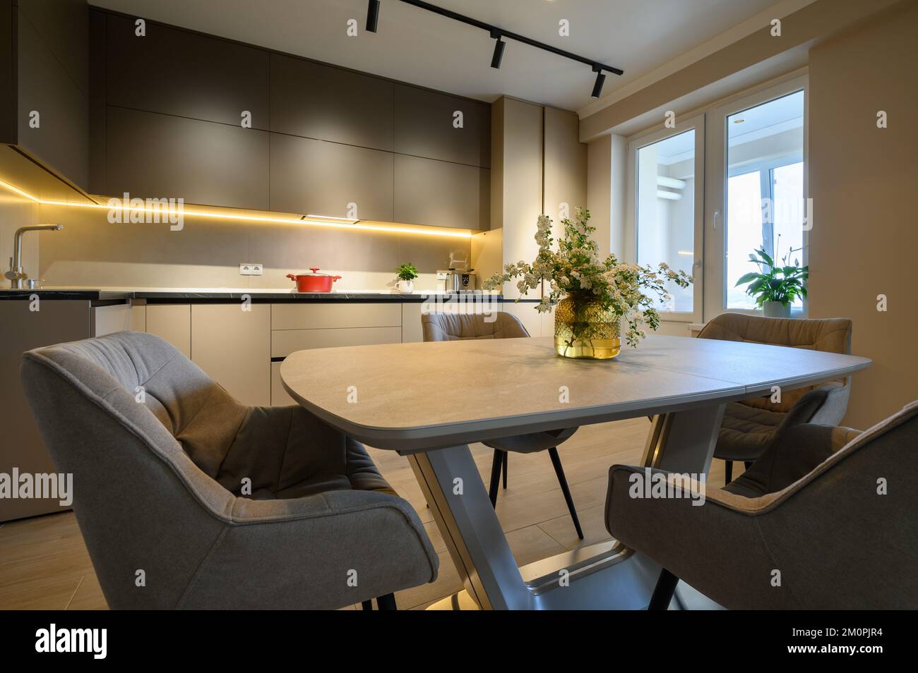 Modern grey luxurious kitchen with dining table in studio apartment ...