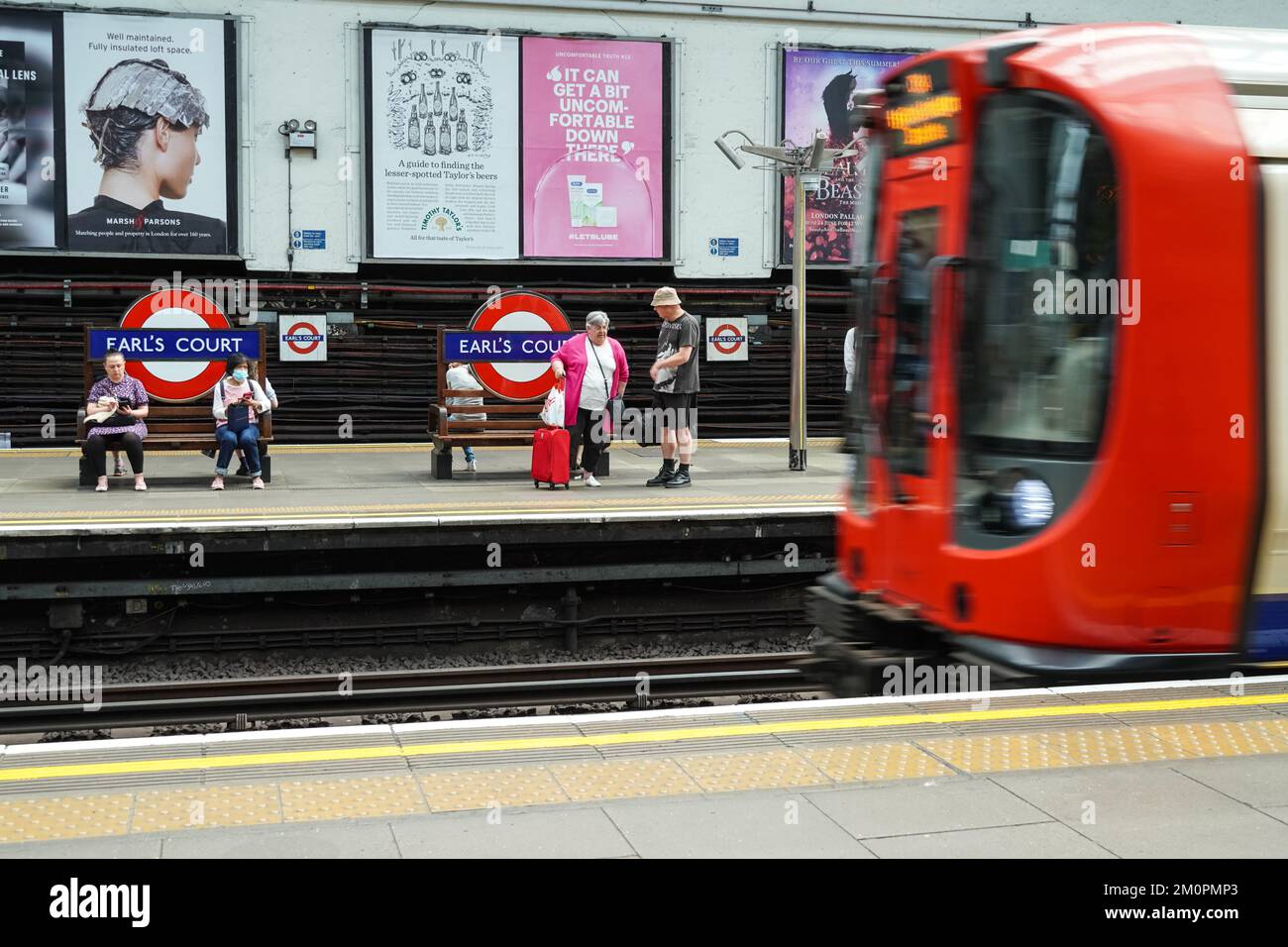 Passengers on platform at Earl's Court underground, tube station London