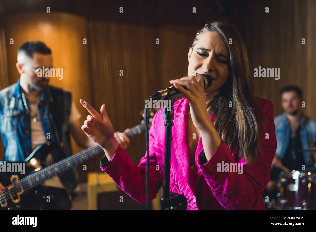 Woman singing and the music band accompanying her. High quality photo Stock Photo