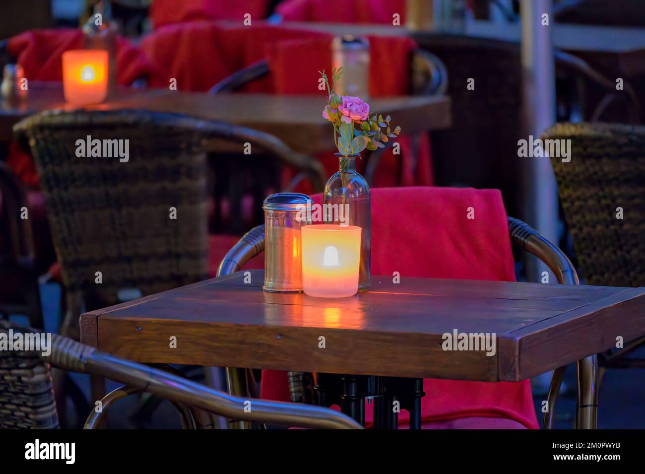 BONN, GERMANY - DECEMBER 6, 2022: Empty restaurant or cafe table with led candle Stock Photo