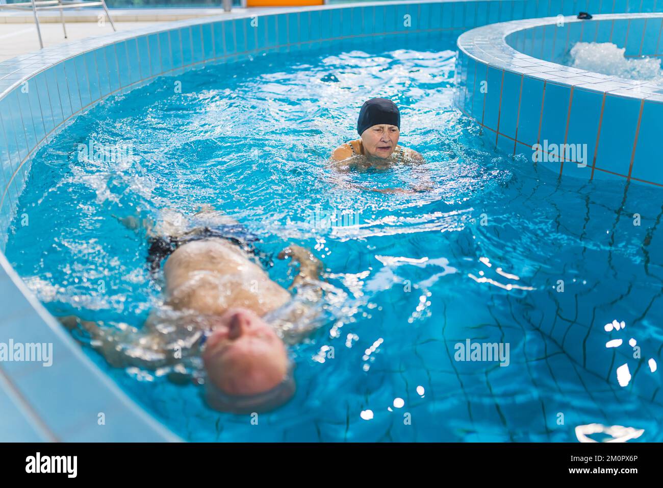Lazy river swimming pool. Caucasian senior married couple enjoying ...