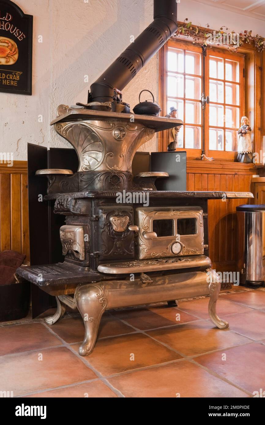 1919 Happy Thought wood burning stove and wooden cupboards in kitchen inside 1974 built replica