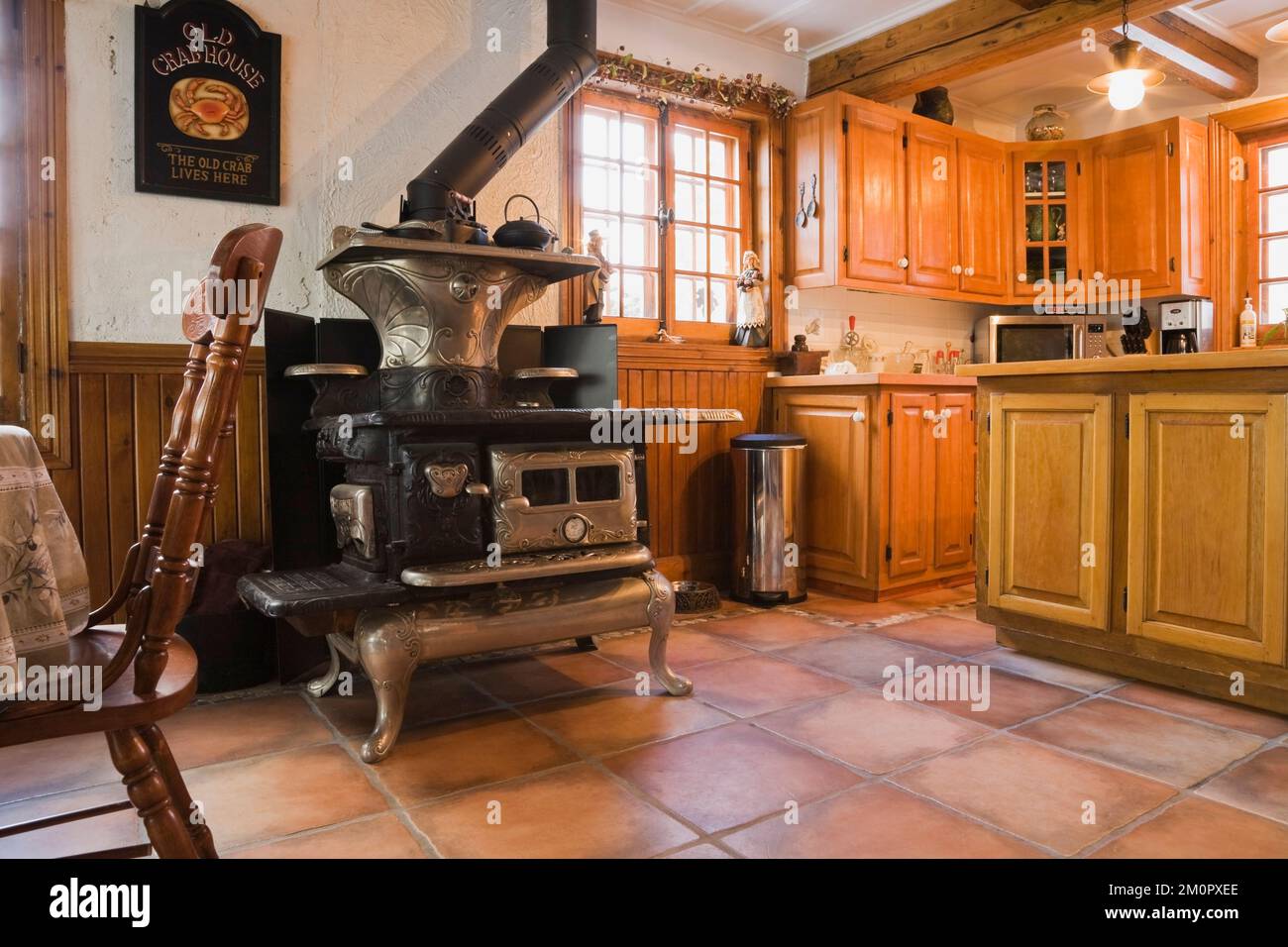 1919 Happy Thought wood burning stove and wooden cupboards in kitchen inside 1974 built replica